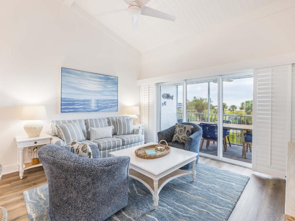 a living room with a couch and a table and chairs at South Seas Resort - Official Site in Captiva