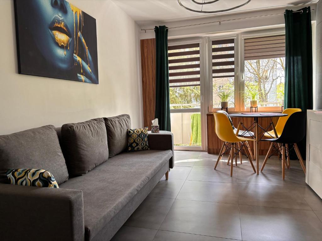 a living room with a couch and a table at Apartament Teresa in Nysa