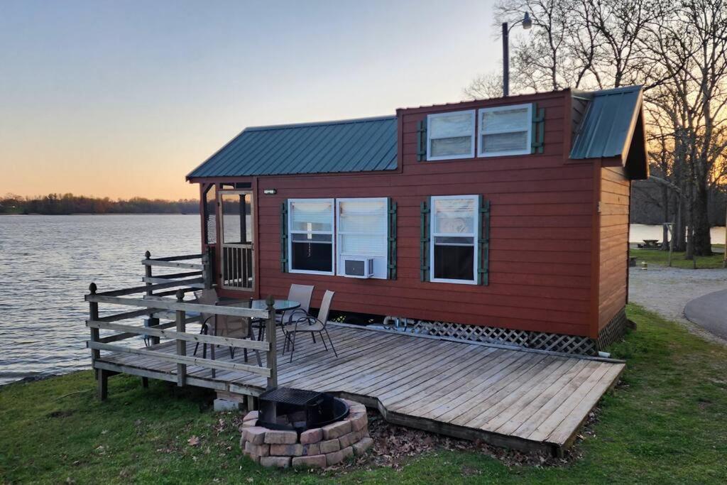 a small house on a dock next to the water at Wheeler Lake Riverbend Haven 2 in Stilwell