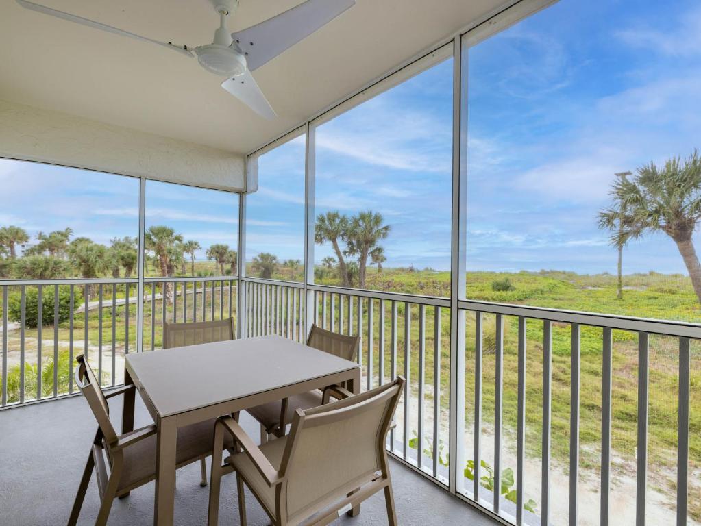 a dining room with a table and chairs on a balcony at South Seas Resort - Official Site in Captiva