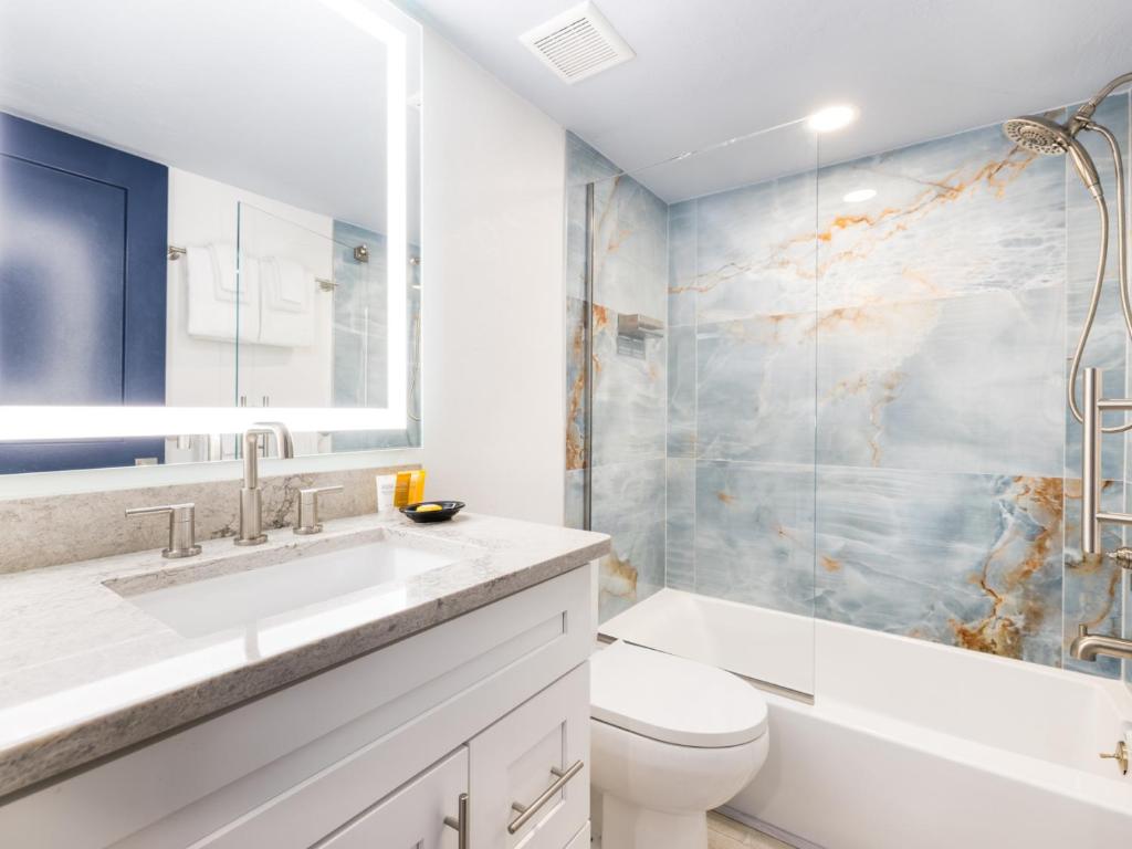 a bathroom with a sink and a toilet and a shower at South Seas Resort - Official Site in Captiva