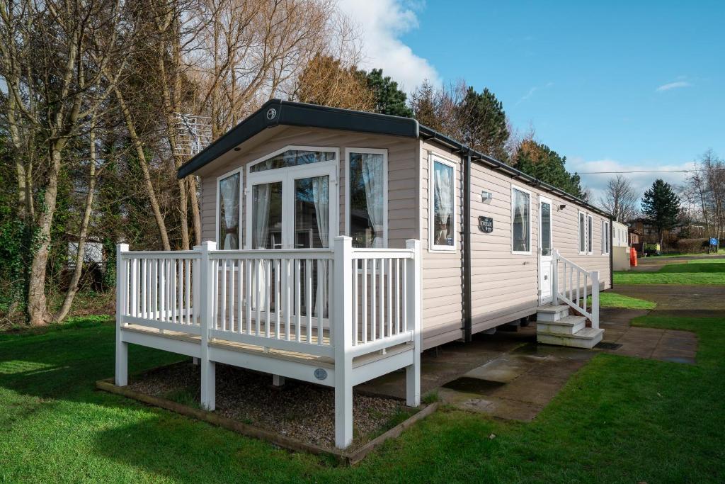 a white tiny house with a black roof at BUNNY - 3 Bed Static Caravan in Port Seton