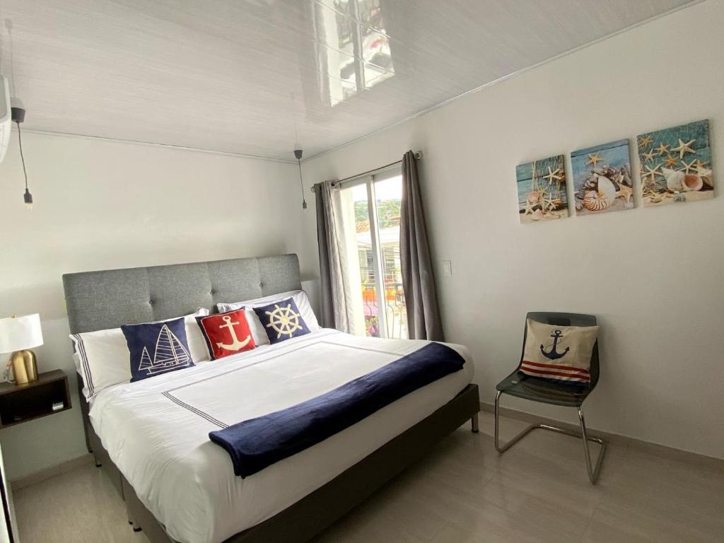 um quarto com uma cama grande e uma cadeira em Hotel Boutique Doña Maria em Ocaña