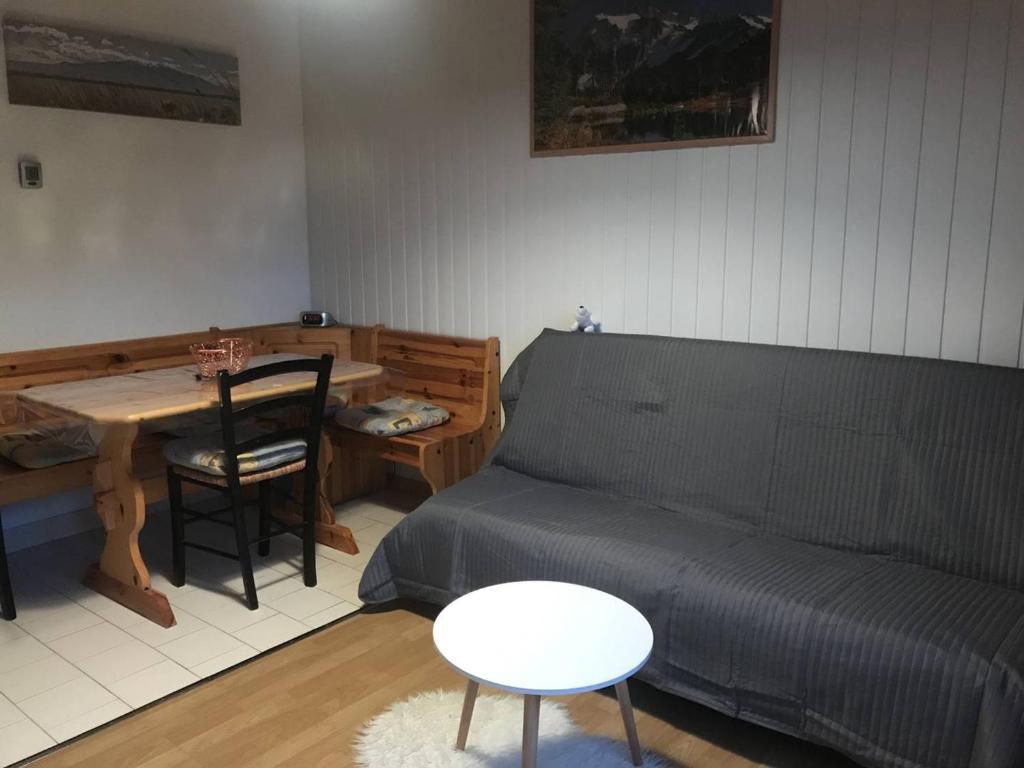 Cette chambre comprend un lit, une table, une table et des chaises. dans l'établissement Charmant T2 au cœur de la station, tout équipé, avec casier à skis et garage - FR-1-593-111, aux Angles