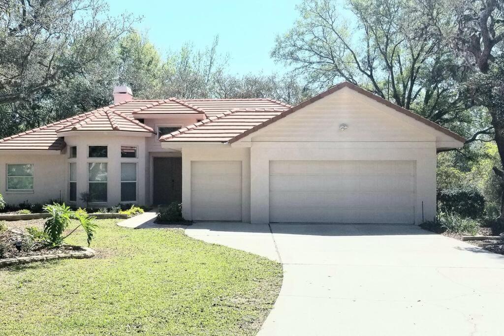 a house with a garage in front of it at Black Diamond Beauty with Concierge Service in Lecanto