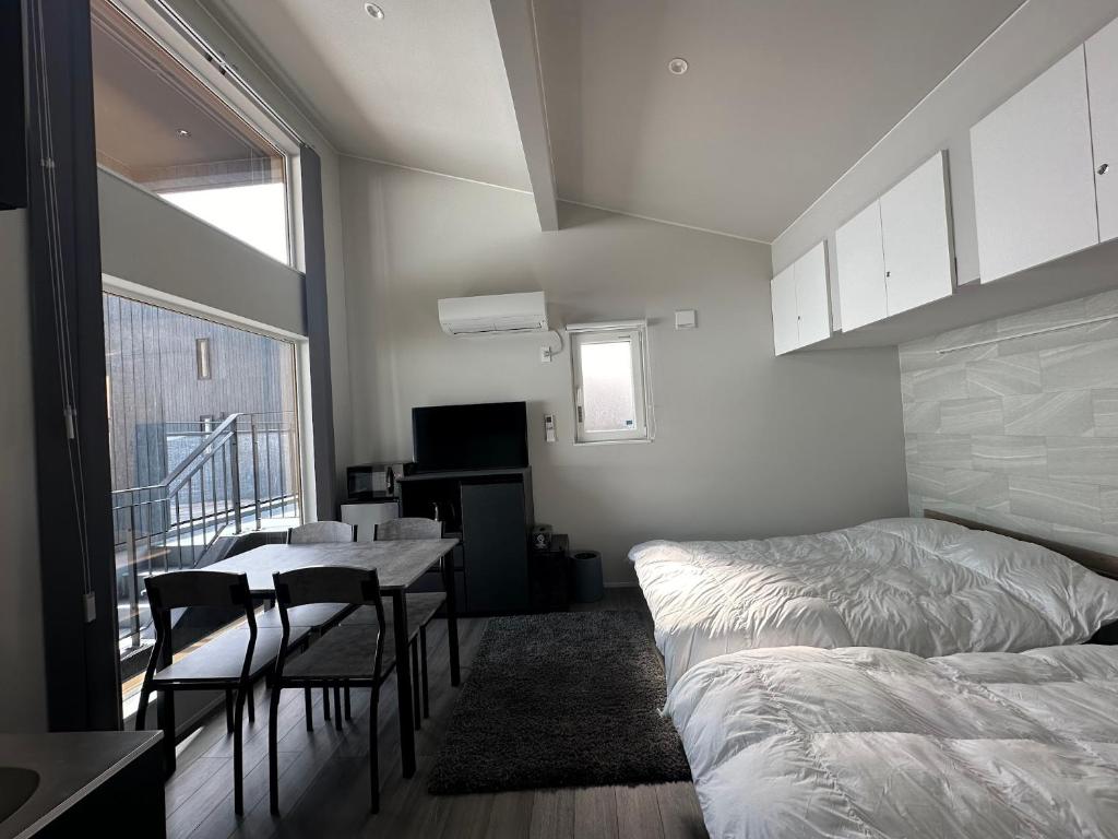 a bedroom with a bed and a table and chairs at Domaine Bless in Niki