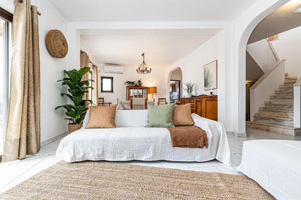 a bedroom with a bed and a staircase at Casa do Vale by Algarve Golden Properties in Porches