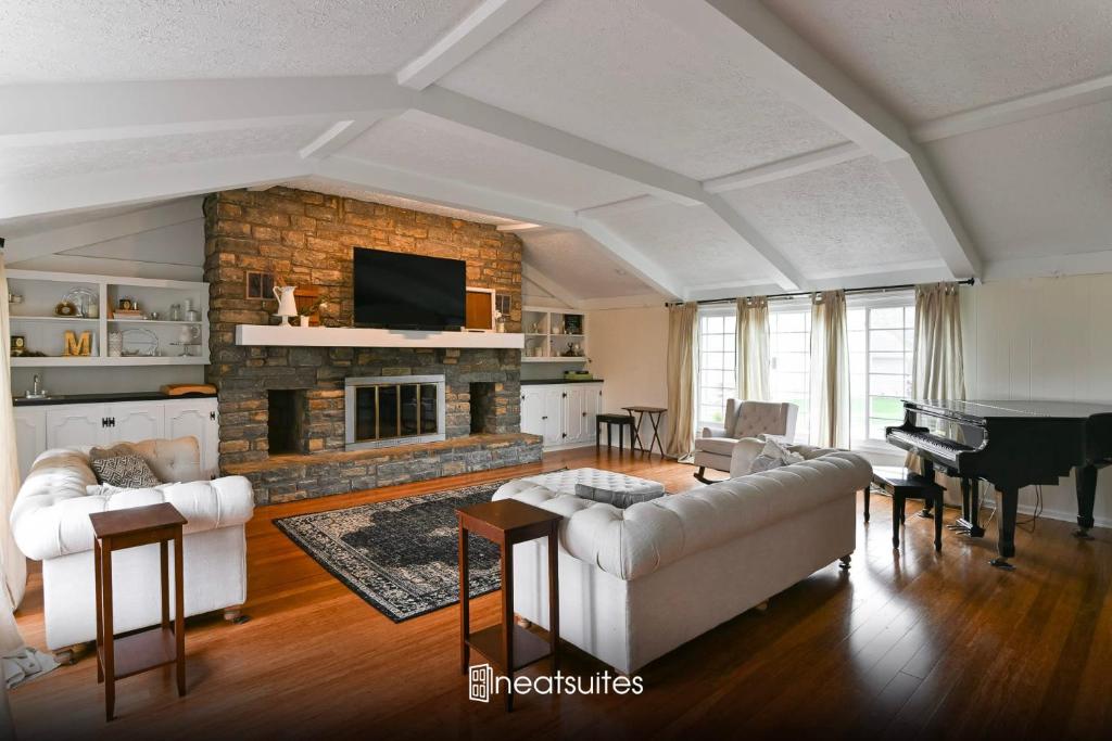 a living room with a couch and a fireplace at Historic Farmhouse with Pool - Sleeps 10 in Union