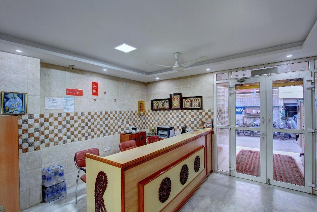 a barber shop with a counter in a room at OYO Hotel Radhakrishna in Madurai