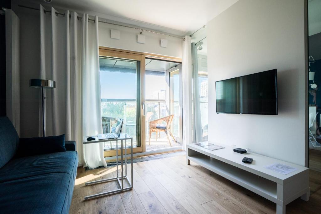 Televízia a/alebo spoločenská miestnosť v ubytovaní VipWarsawApartments Sapphire Mennica Residence