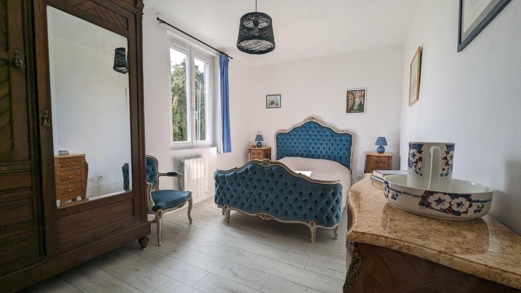 baño con lavabo y 2 sillas azules en Gîte chez Loupi, en Épaignes
