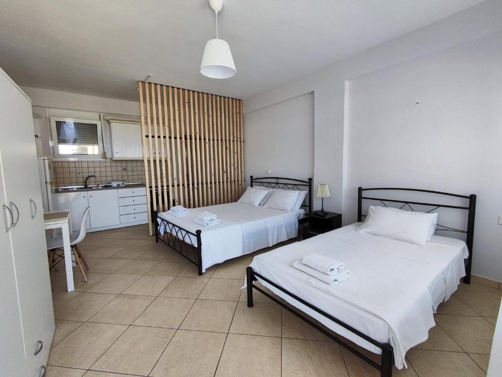 Ένα ή περισσότερα κρεβάτια σε δωμάτιο στο Philoxenia Apartments