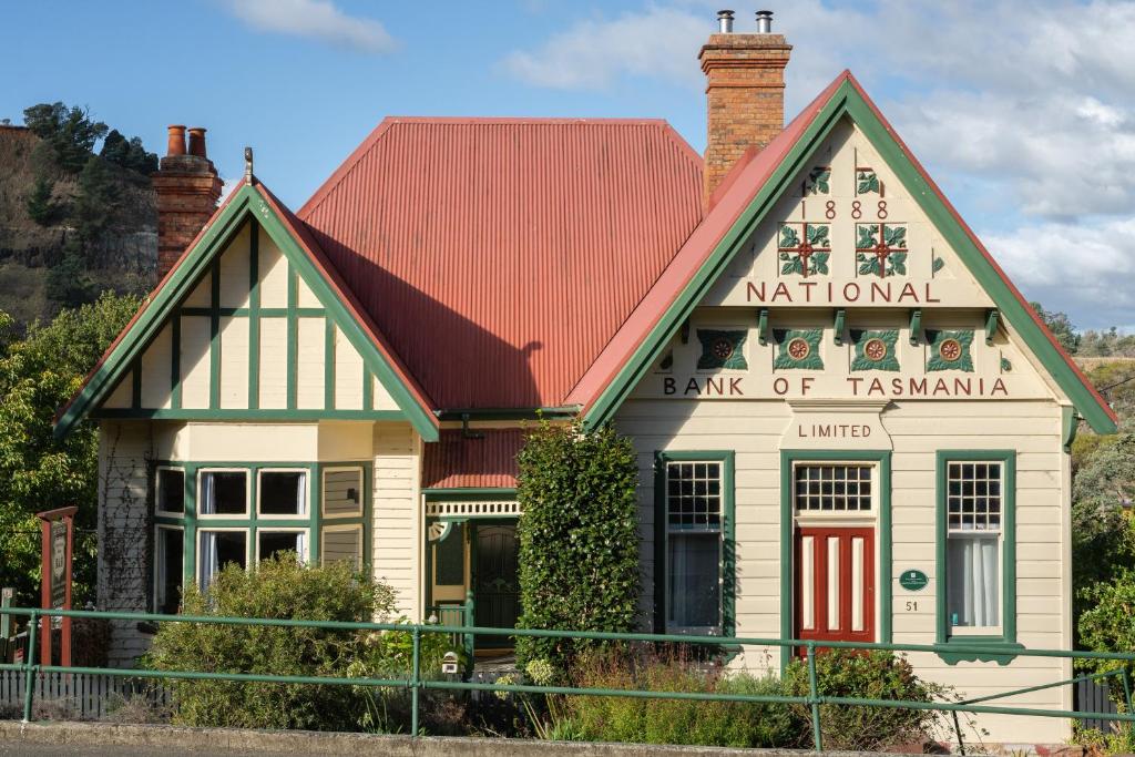 a building with a sign that reads national bank of tasmania at Derby Bank House- Heritage listed two bedroom old school B&B suite or a self contained cabin in Derby