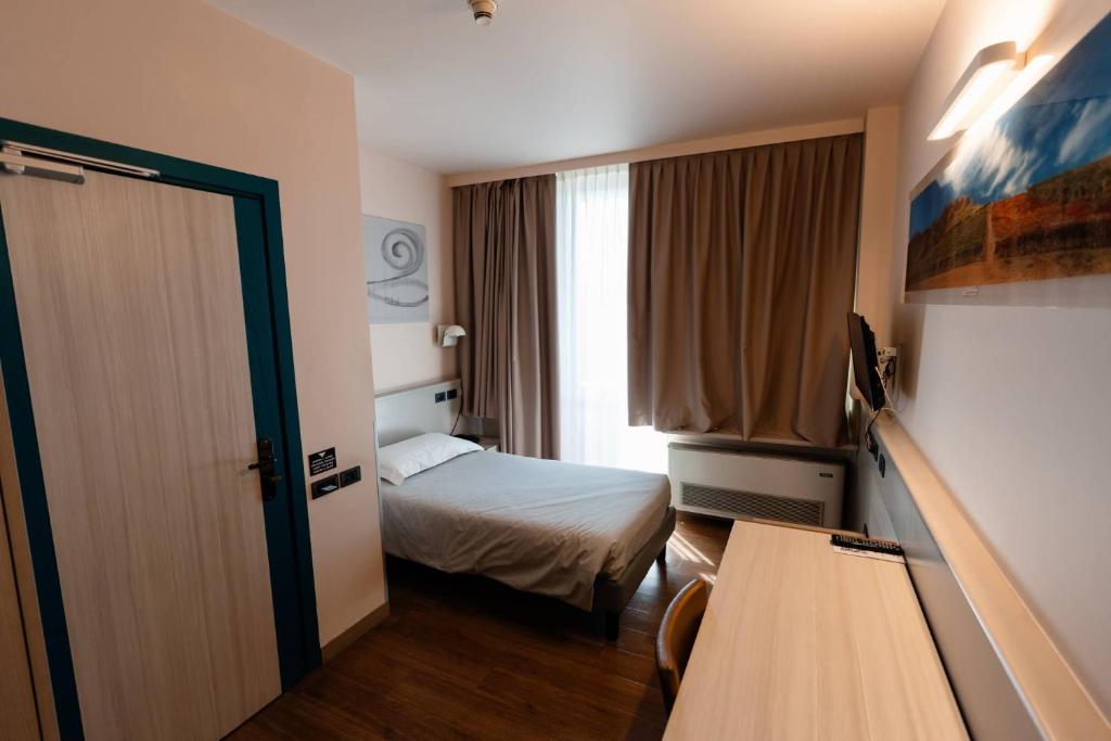 Postel nebo postele na pokoji v ubytování Hotel Ristorante I Castelli