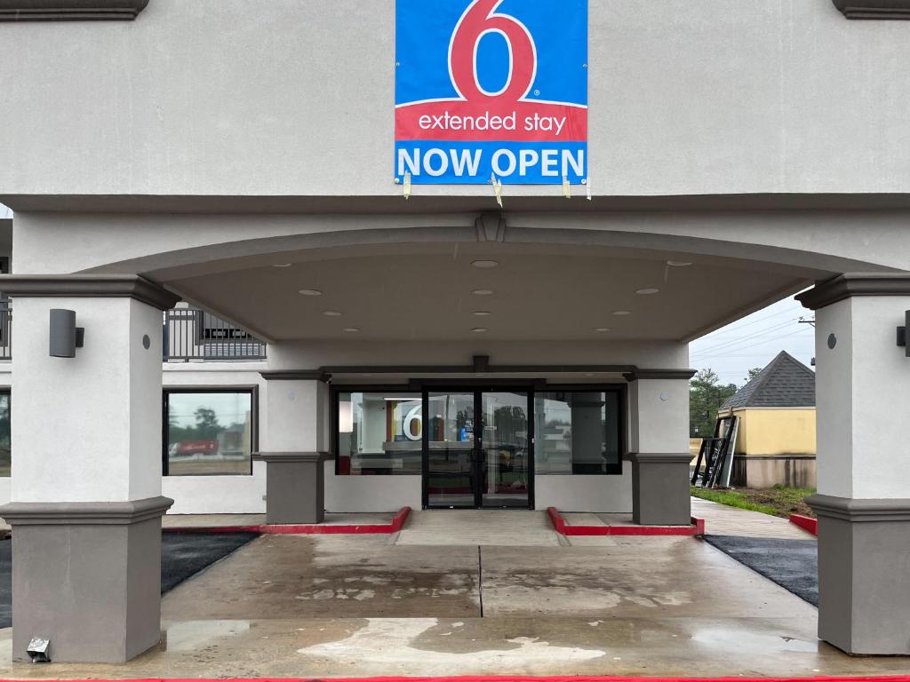 a new office building with a now open sign on it at Studio 6 Conroe, TX in Conroe