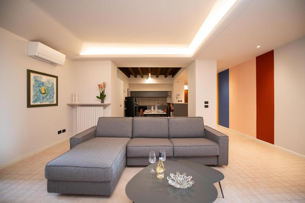 a living room with a couch and a table at Casa sul Porto in Desenzano del Garda