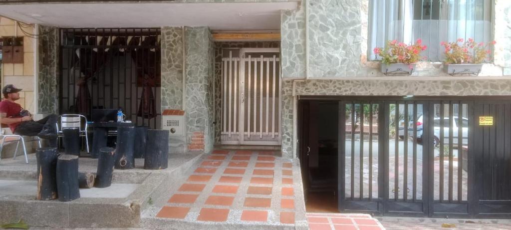 an entrance to a building with a wrought iron gate at K-zona 70 in Medellín