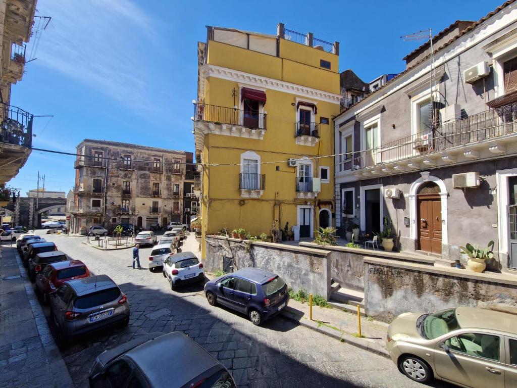 a group of cars parked on a city street at Elvira Home in Catania