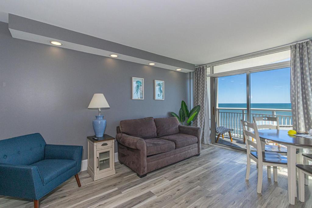 a living room with a couch and a table at Oceanfront One Bedroom Suite-Atlantica 803 in Myrtle Beach
