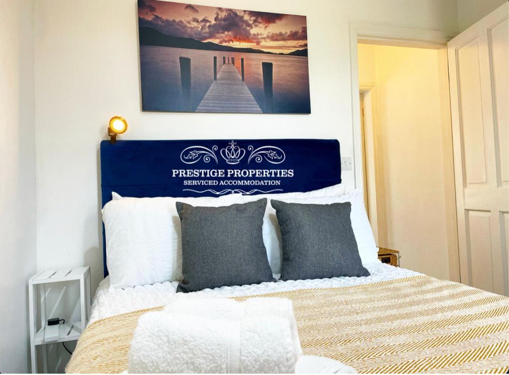 a bedroom with a bed with a poster on the wall at Blakefell by Prestige Properties SA in Arlecdon