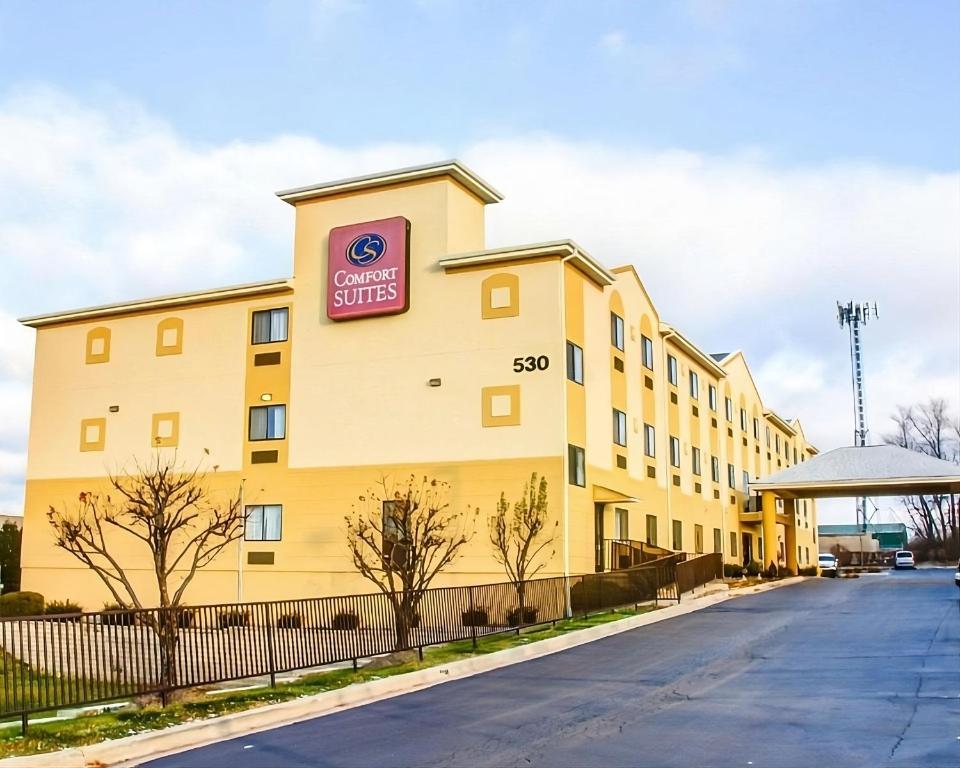 a large yellow building with a sign on it at Comfort Suites Lombard/Addison in Lombard