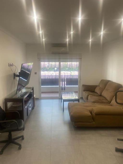 a living room with a couch and a piano at 2 Bed Apartment in Gibraltar - Marina Views in Gibraltar