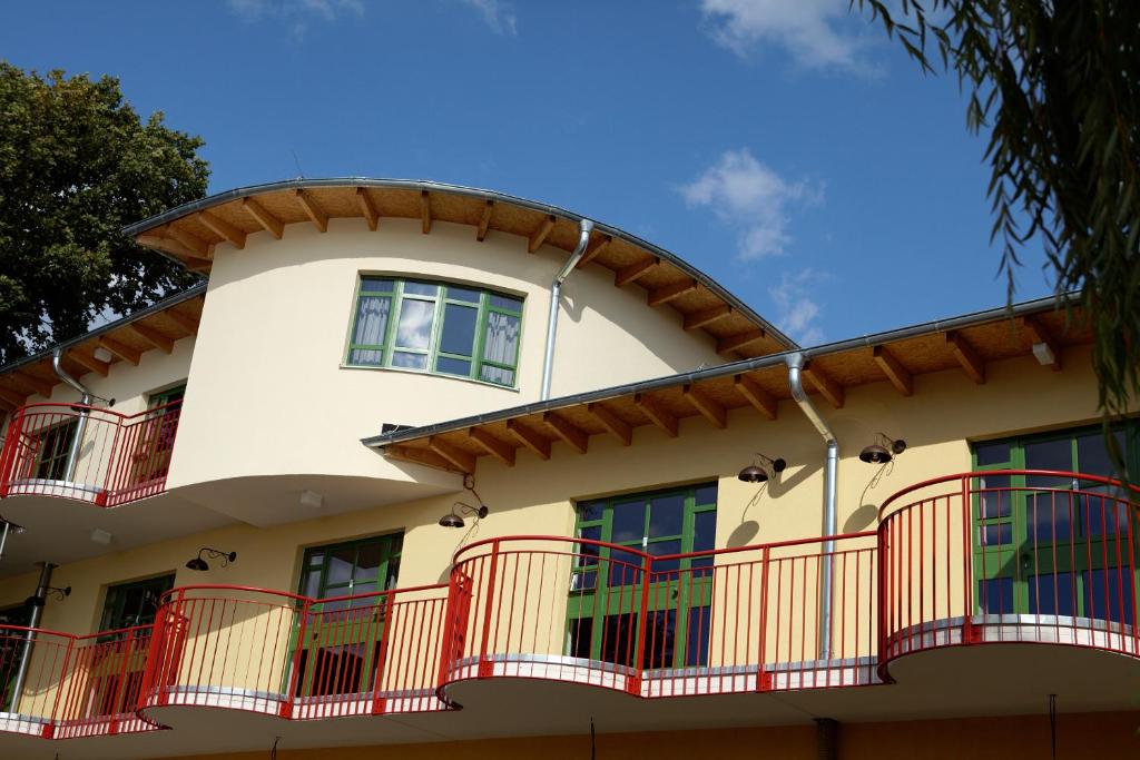 a building with red balconies and a blue sky at Seminar- und Gästehaus Flussbad Gartenstrasse in Berlin