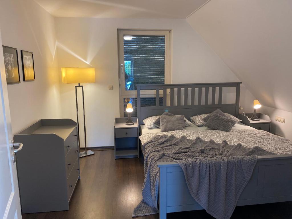 um quarto com uma cama e duas mesas de cabeceira e uma janela em Ellerau Home em Ellerau