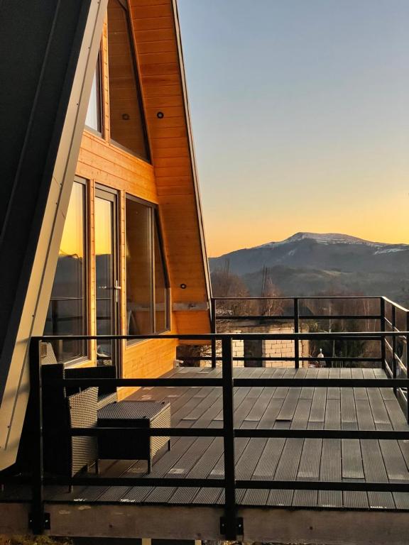 a balcony of a house with a view of the mountains at Cez A-Frame in Petroşani