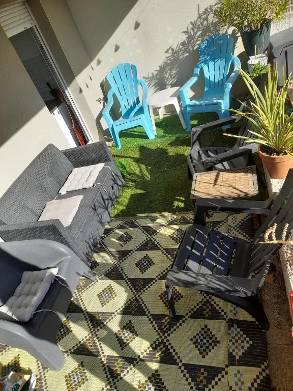 - un ensemble de chaises bleues assises sur une terrasse dans l'établissement Appartement cosy et lumineux, à Marseille