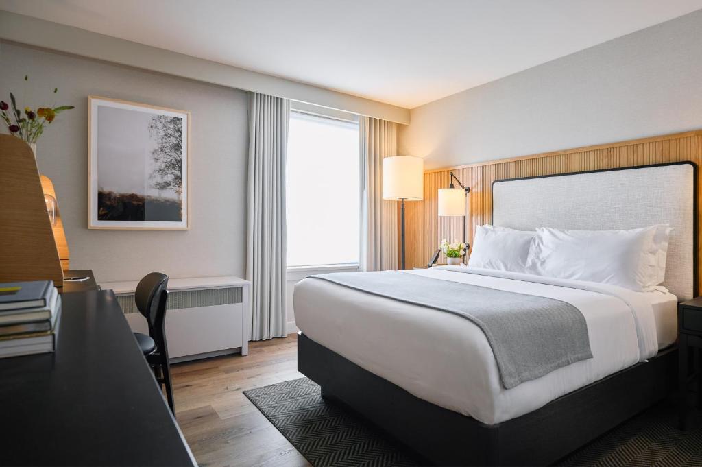 um quarto de hotel com uma cama grande e uma secretária em The Watershed - Formerly Hotel Zero Degrees em Norwalk