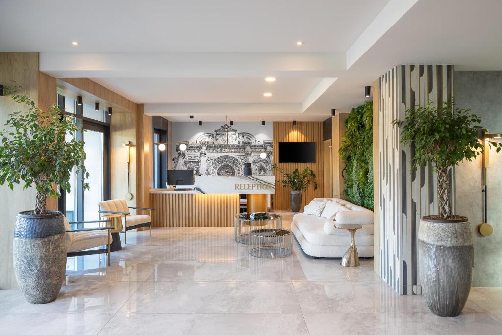 a living room with a couch and a table at Hotel Branco Timisoara in Timişoara