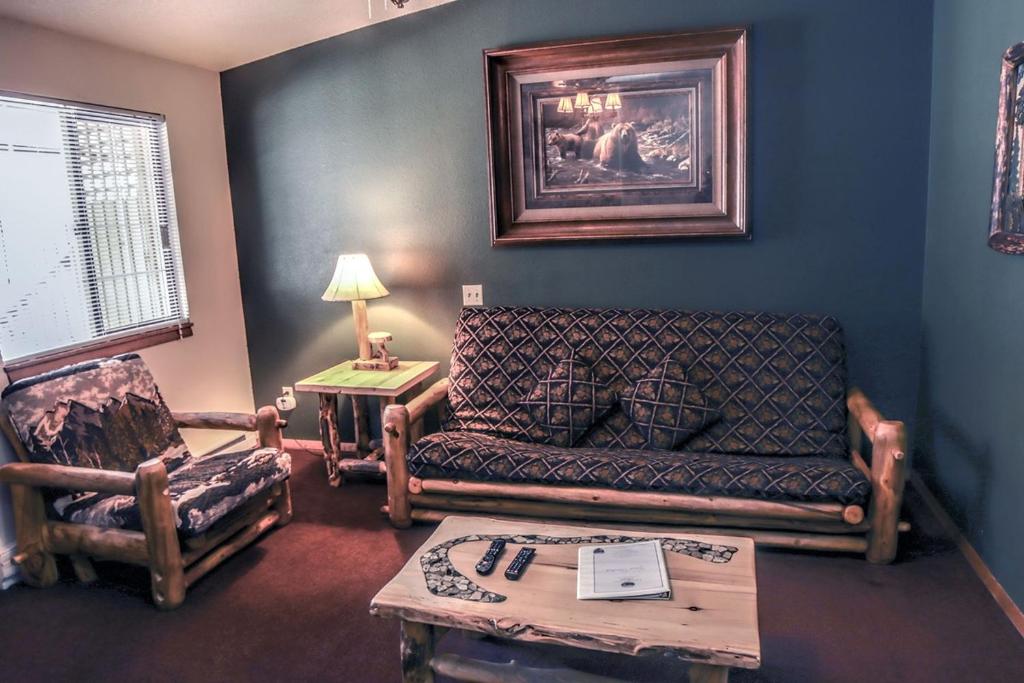 a living room with a couch and a chair at Timber Creek Chalets- 6 chalet in Estes Park