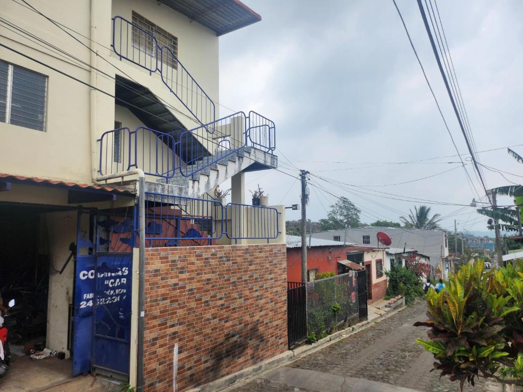 a building with a staircase on the side of it at Hostal Carolinas in Juayúa