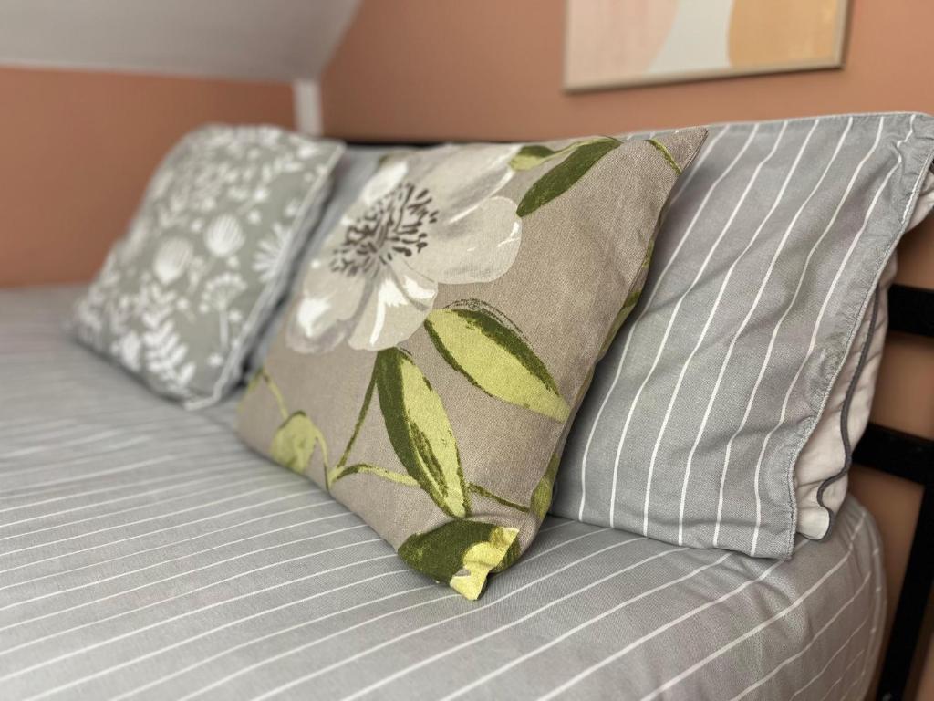 a bed with two pillows on top of it at Mini hotel with home facilities in Hamilton West in High Blantyre