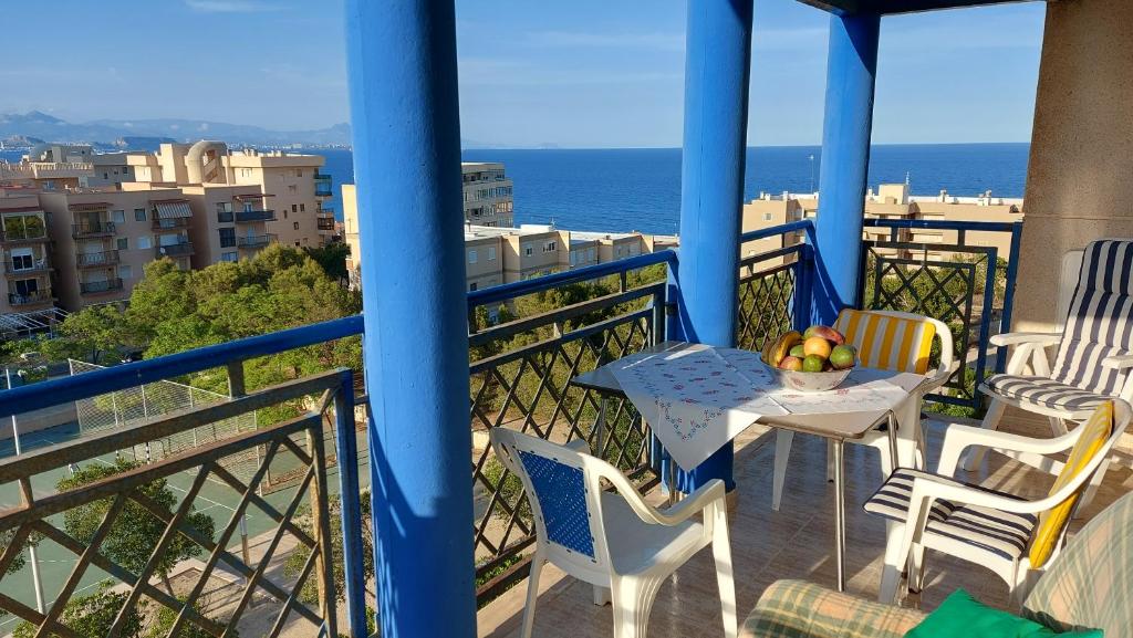 a balcony with a table and chairs and the ocean at Arenales Sea View Apartment in Arenales del Sol