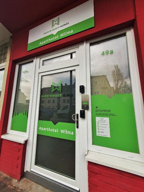 a store front with glass doors and signs on it at Aparthotel Wilma in Bremen