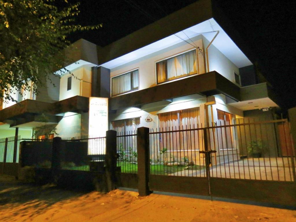 a house with a fence in front of it at night at Hostal La Cumbre in Temuco