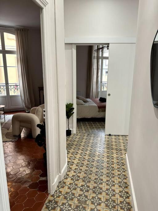 a hallway of a living room with a couch and a living room at La Réal - Apt 2 chambres rénové in Perpignan