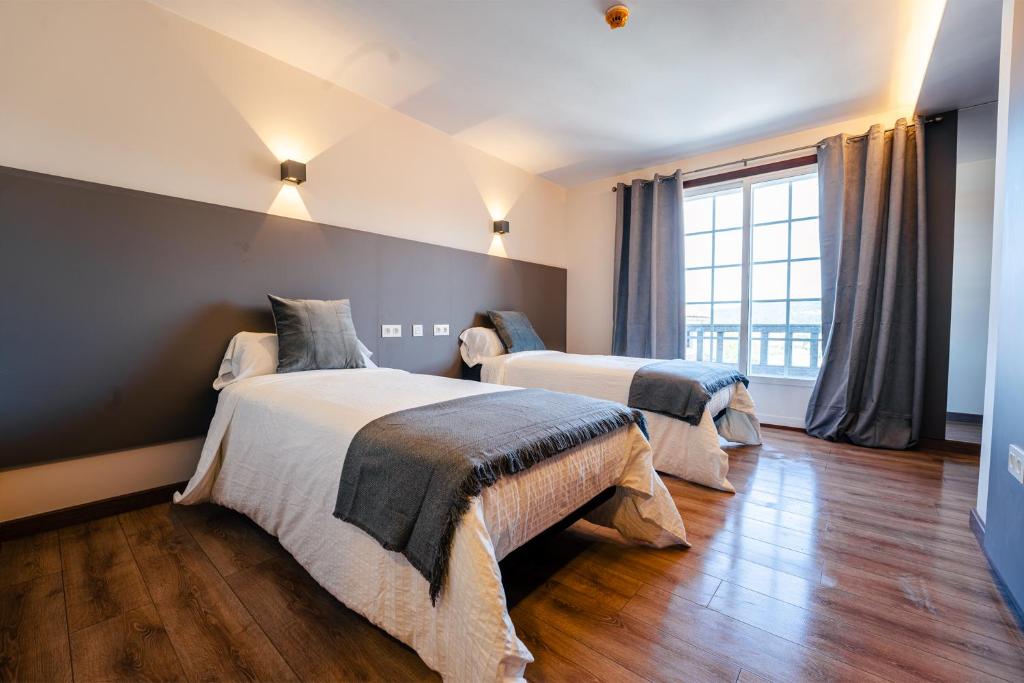 Кровать или кровати в номере Hotel Restaurante GBC Isape
