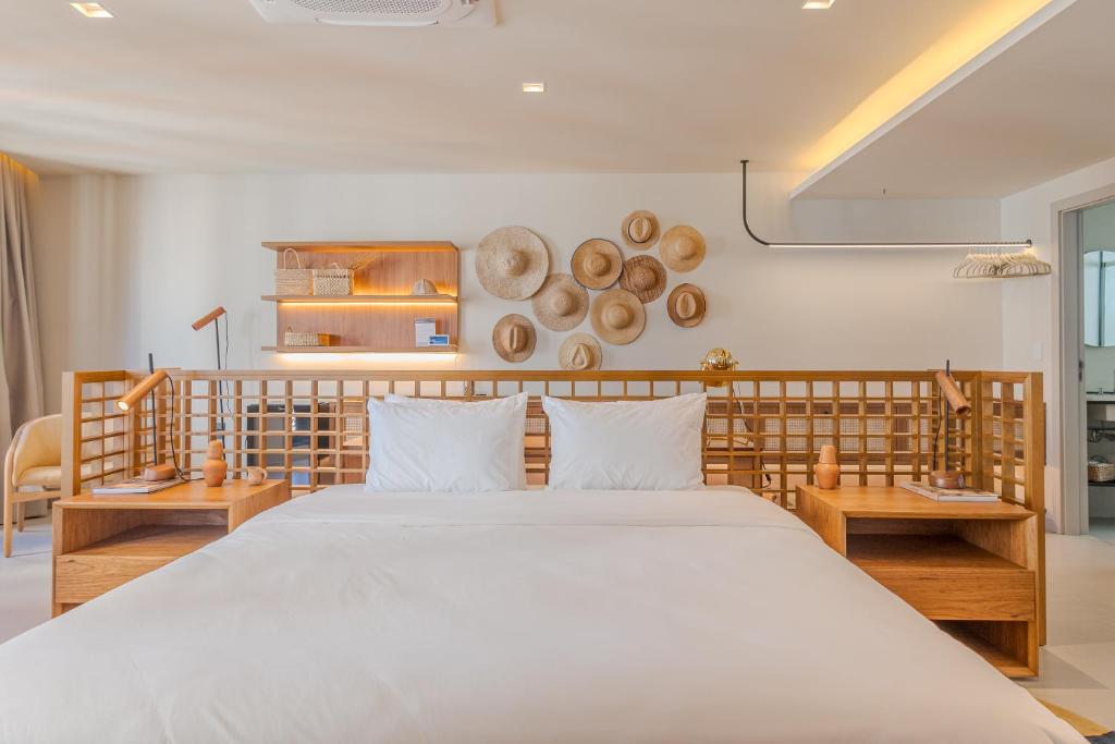 a bedroom with a large bed and wooden furniture at Gorges Residence Salvador in Salvador