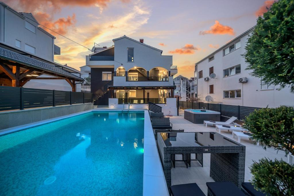 a swimming pool in the backyard of a house at Villa Diamond in Trogir