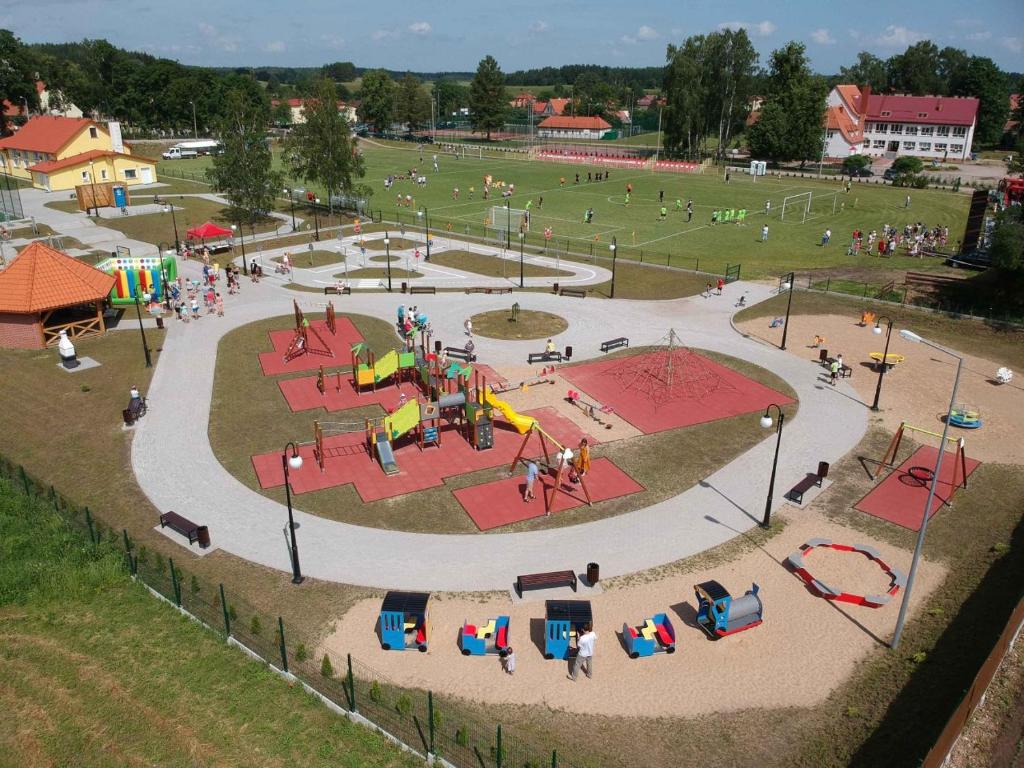 a park with a playground with people in it at W sercu Mazur in Kruklanki