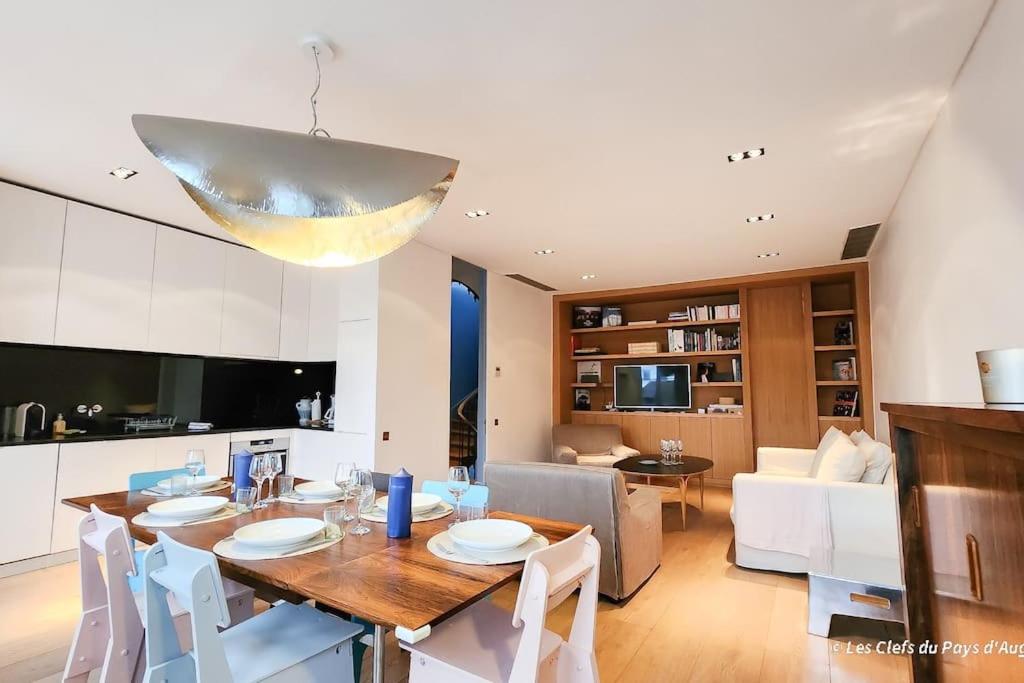 cocina y sala de estar con mesa y sillas en Superbe maison de standing-plein cœur de Deauville, en Deauville