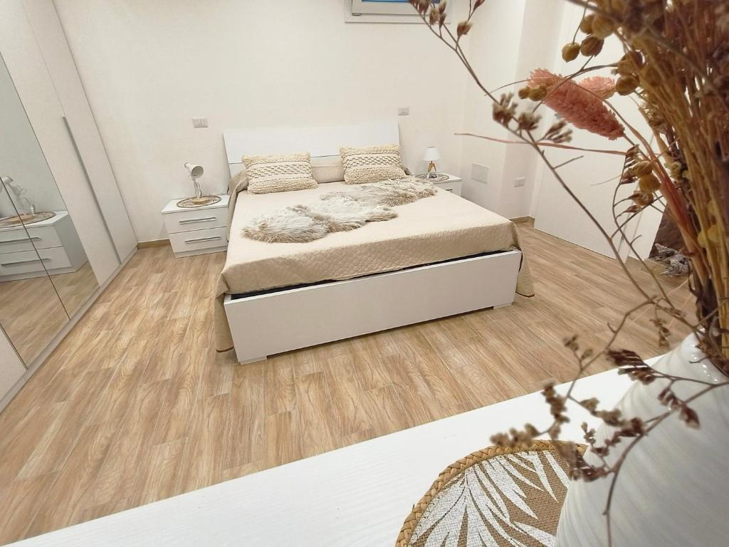 a bedroom with a bed and a wooden floor at House La Torricella in Vetriolo