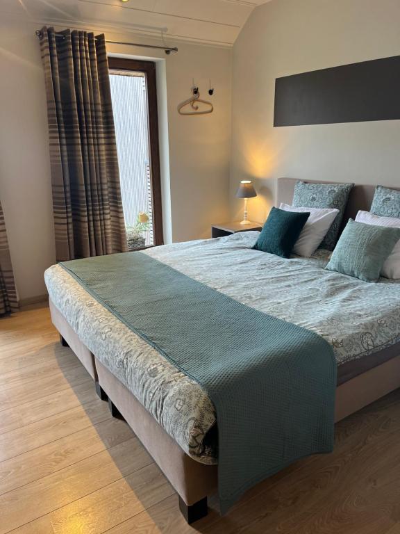 a bedroom with a large bed in a room at B&B au 27 in Stavelot