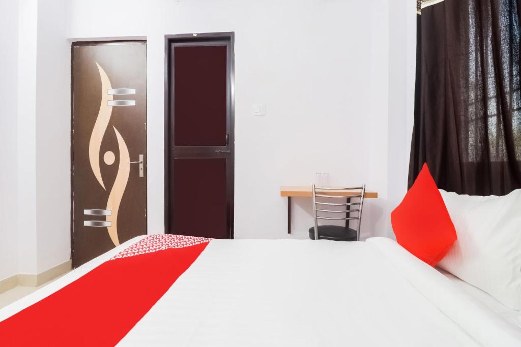 a bedroom with a bed with a red blanket on it at Flagship Flagship Hotel Dream Inn in Dānāpur