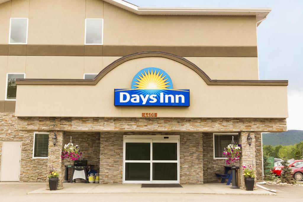 a day inn sign on the front of a building at Days Inn by Wyndham Chetwynd in Chetwynd