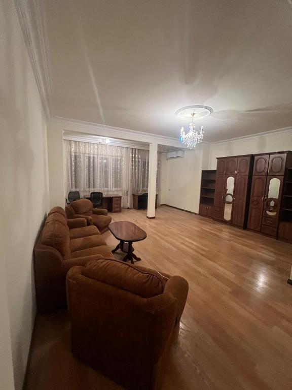 a living room with couches and a table in it at Opera Guest House in Yerevan