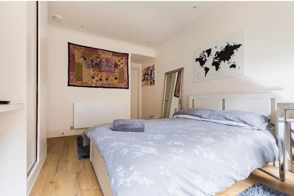 a bedroom with a large white bed in it at Private room with en-suite in London